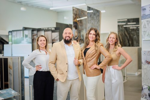 Flooring team portrait inside a showroom with tile displays