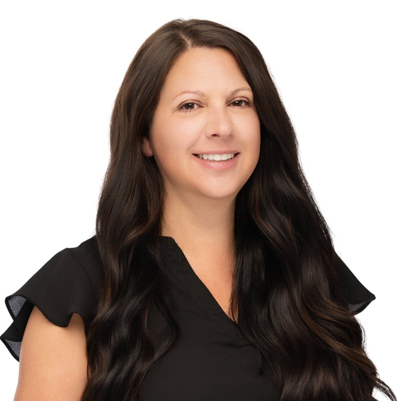 Dees Insurance studio headshot on a white background — black blouse and long dark hair