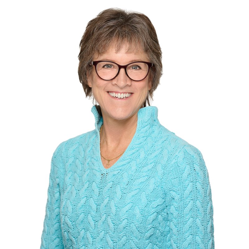 Dees Insurance studio headshot on a white background — turquoise sweater and glasses