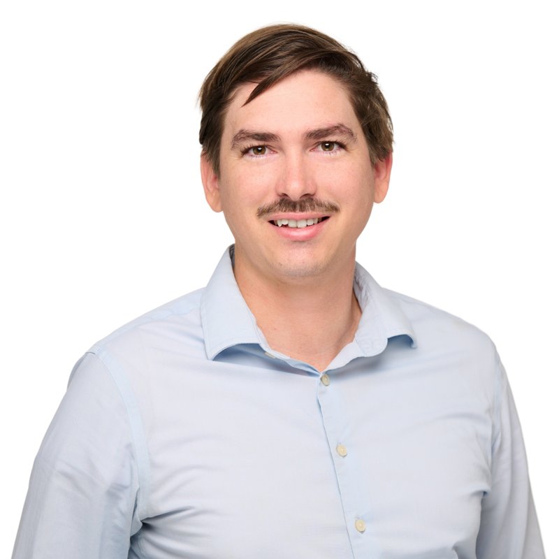 Dees Insurance studio headshot on a white background — light blue shirt