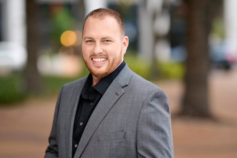 Zarghami Group portrait in downtown Sarasota — gray blazer and black shirt