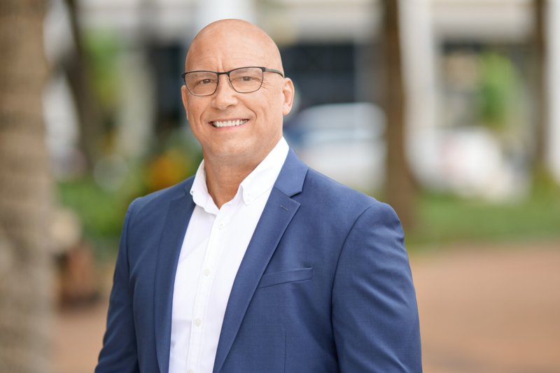 Zarghami Group portrait in downtown Sarasota — glasses, blue blazer and white shirt
