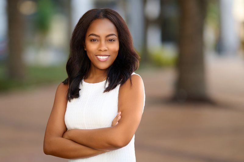 Zarghami Group portrait in downtown Sarasota — white sleeveless top and folded arms